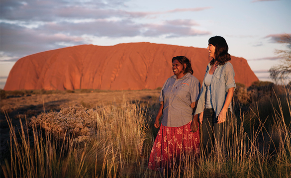 Two ladies in front of Ayers Rock in Australia/