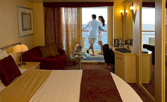 Couple on the balcony of a Stateroom cabin on Celebrity Constellation cruise ship/