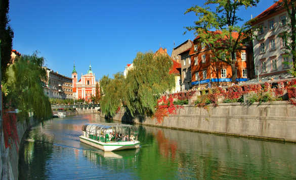 Sightseeing boat cruising along the River Ljubljanica through Slovenia's Capital city, Ljubljana/
