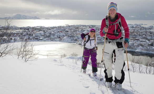 Couple cross country skiing in the Lofoten Islands, Norway/