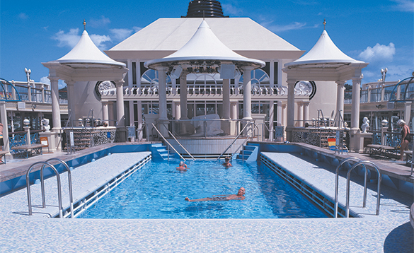 Passengers relaxing in the pool onboard a NCL cruise ship/