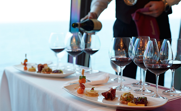 Waiter pouring wines for a wine tasting event onboard an Oceania cruise ship/