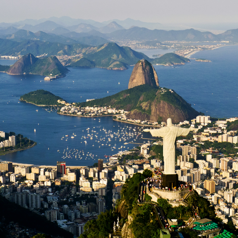 Brazil-Rio High-angle panoramic view of Rio de Janeiro, highlighting the Christ the Redeemer statue overlooking the bay and city.