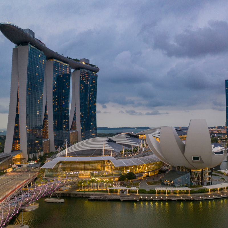 Singapore Dusk view of the Marina Bay Sands hotel and the lotus-shaped Art Science Museum illuminated in Singapore