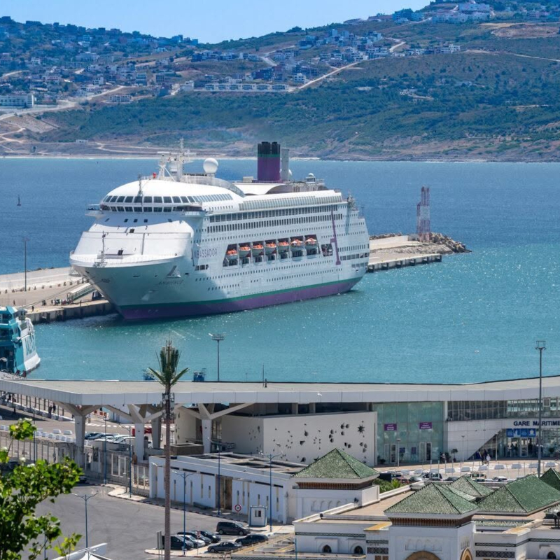 Ambassador-Ambition-Tangier-Morocco An Ambassador cruise ship docked at the Tangier maritime port in Morocco with rolling hills in the background.
