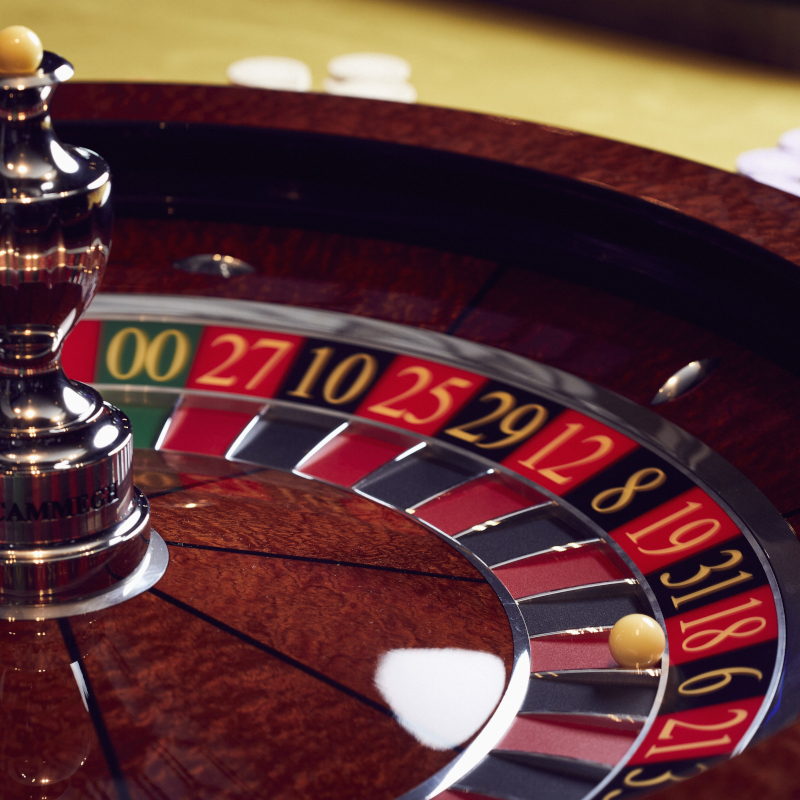 P&O-Cruises-casino Close-up of a roulette wheel with a ball landing on a winning number inside a cruise ship casino.